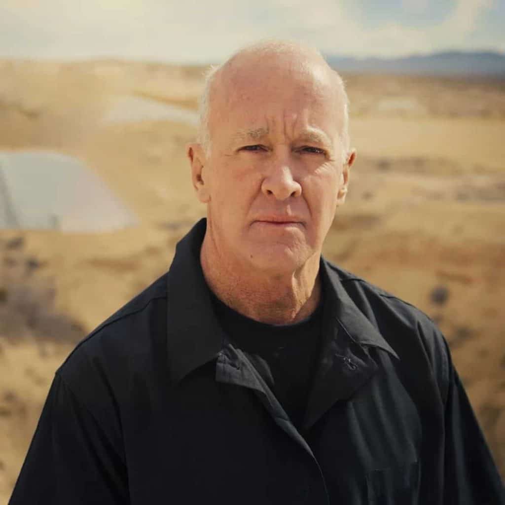 Don Mann, Face Off host, in a black shirt against a desert training range